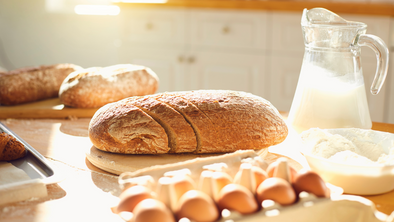 How does a bread box help keep bread fresh?